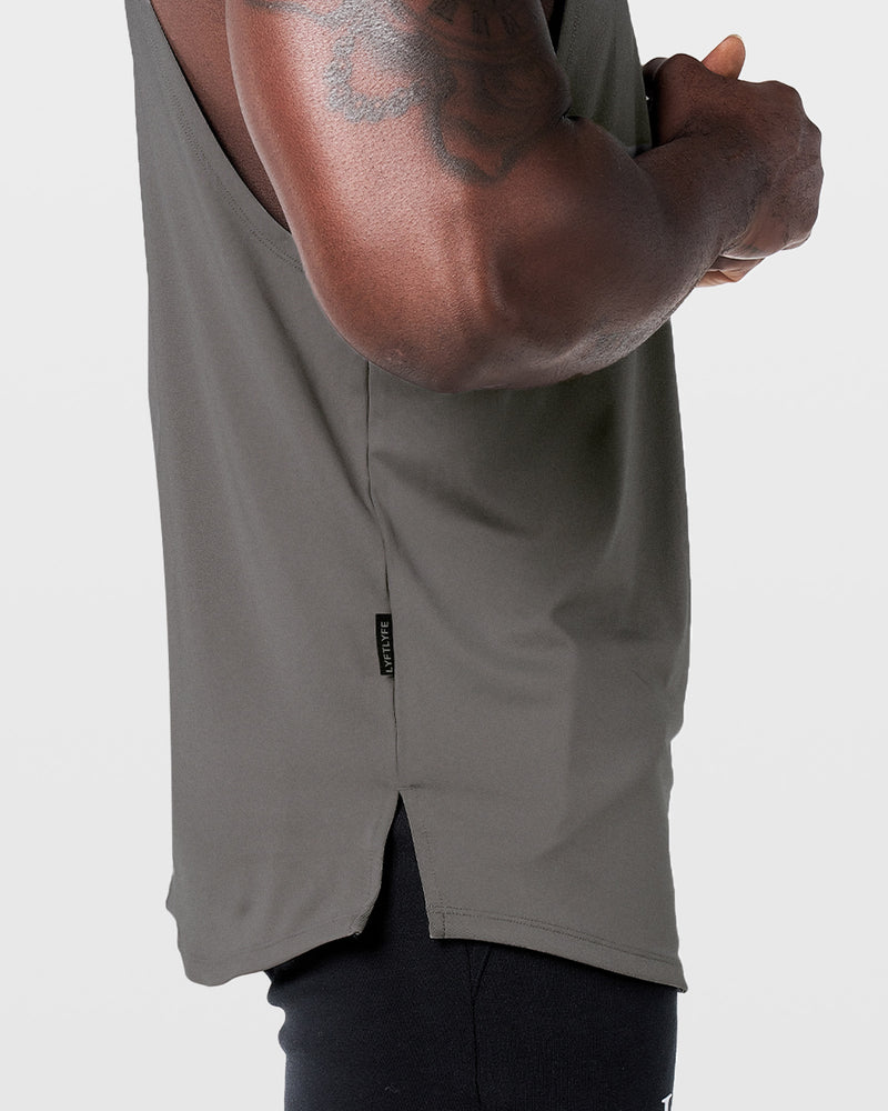 Mens sleeveless tank top in dark grey with a reflective Dominate Adversity logo at center chest.