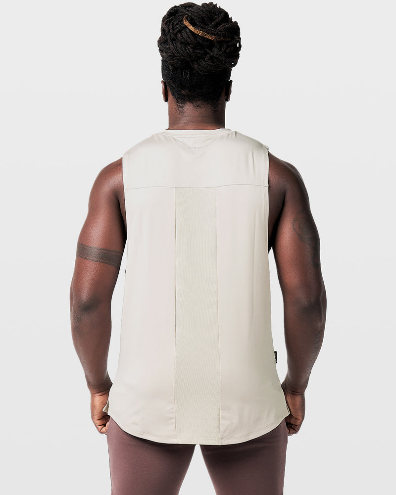 Off white mens sleeveless tank top with a reflective Dominate Adversity logo at center chest.