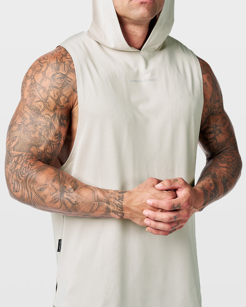 Mens hooded tank top in off white with a reflective Dominate Adversity logo at center chest.