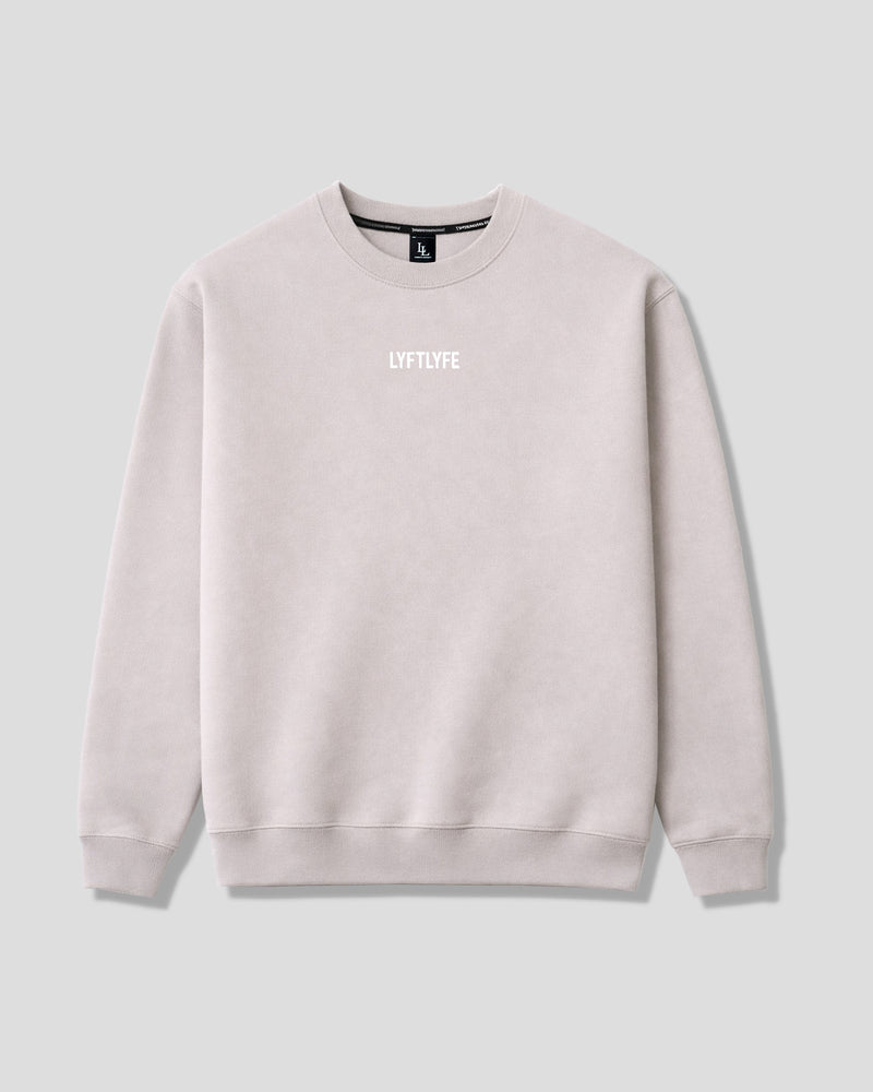 Oversized women's crewneck in off-white with a brand logo on a light gray background