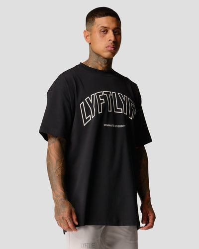 A male athlete is in a black oversized T-shirt with a large lyftlyfe logo on the chest.