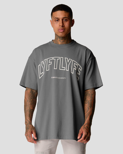 Men’s oversized grey T-shirt with Lyftlyfe logo and 'Dominate Adversity' slogan, made from soft premium cotton.