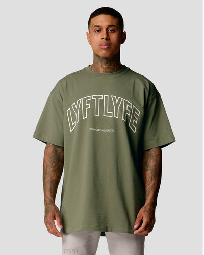 A male athlete is in a green oversized T-shirt with a large lyftlyfe logo on the chest.