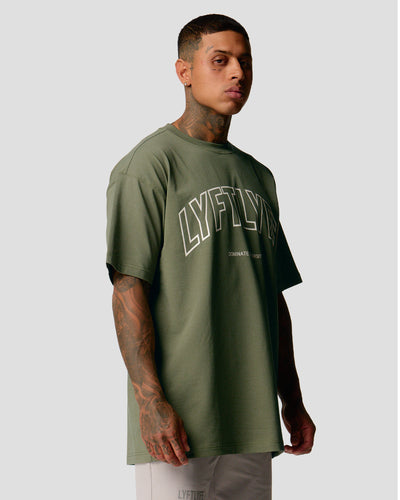 A male athlete is in a green oversized T-shirt with a large lyftlyfe logo on the chest.