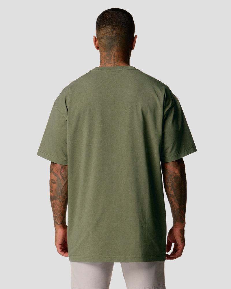 A male athlete is in a green oversized T-shirt with a large lyftlyfe logo on the chest.