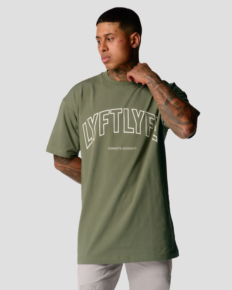 A male athlete is in a green oversized T-shirt with a large lyftlyfe logo on the chest.