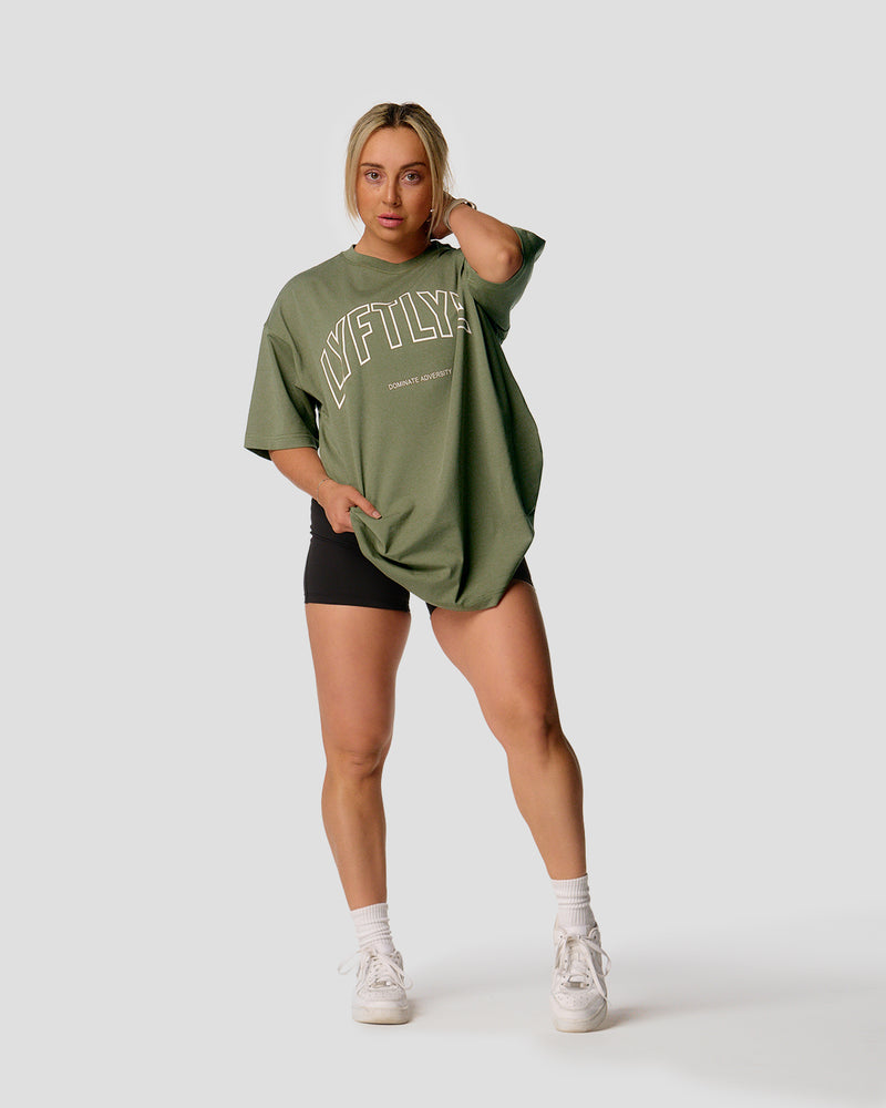 A female athlete is wearing a r, oversized T-shirt featuring a large lyftlyfe logo across the chest.green