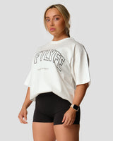 Left side view of Women's oversized T-shirt in white, cotton, with a large Lyftlyfe logo on the chest.

