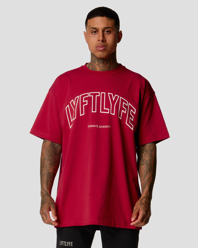 A male athlete is wearing a red, oversized T-shirt featuring a large lyftlyfe logo across the chest.