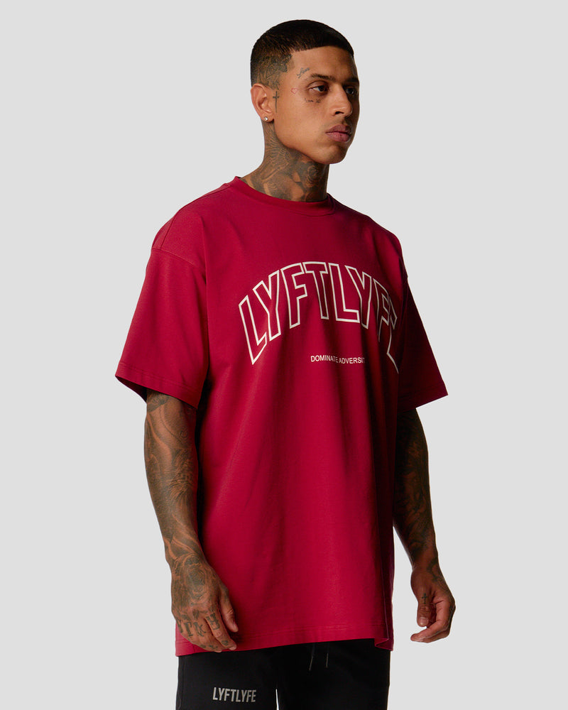 A male athlete is wearing a red, oversized T-shirt featuring a large lyftlyfe logo across the chest.