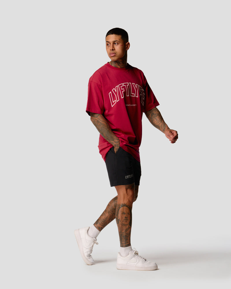 A male athlete is wearing a red, oversized T-shirt featuring a large lyftlyfe logo across the chest.