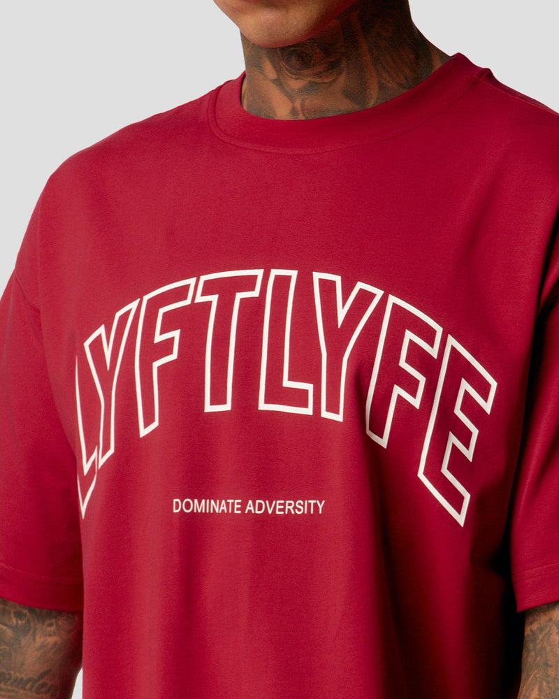 A male athlete is wearing a red, oversized T-shirt featuring a large lyftlyfe logo across the chest.