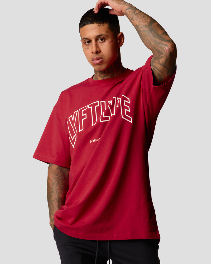 A male athlete is wearing a red, oversized T-shirt featuring a large lyftlyfe logo across the chest.