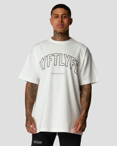 A male athlete is wearing a white, oversized T-shirt featuring a large lyftlyfe logo across the chest.