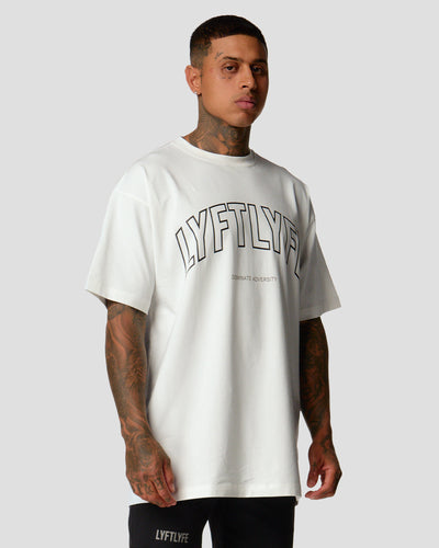 A male athlete is wearing a white, oversized T-shirt featuring a large lyftlyfe logo across the chest.