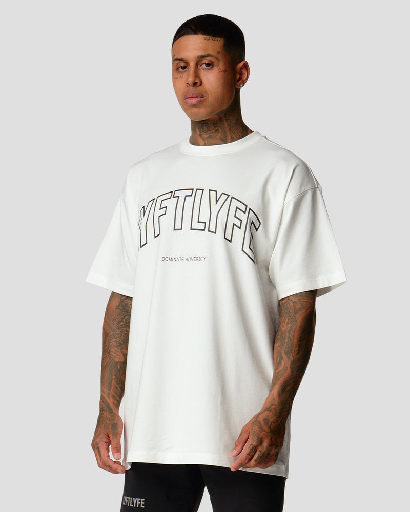 A male athlete is wearing a white, oversized T-shirt featuring a large lyftlyfe logo across the chest.