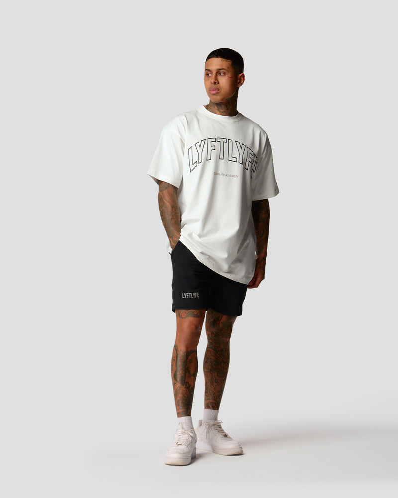 A male athlete is wearing a white, oversized T-shirt featuring a large lyftlyfe logo across the chest.