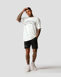 White oversized men’s T-shirt with bold black Lyftlyfe branding and empowering 'Dominate Adversity' slogan.