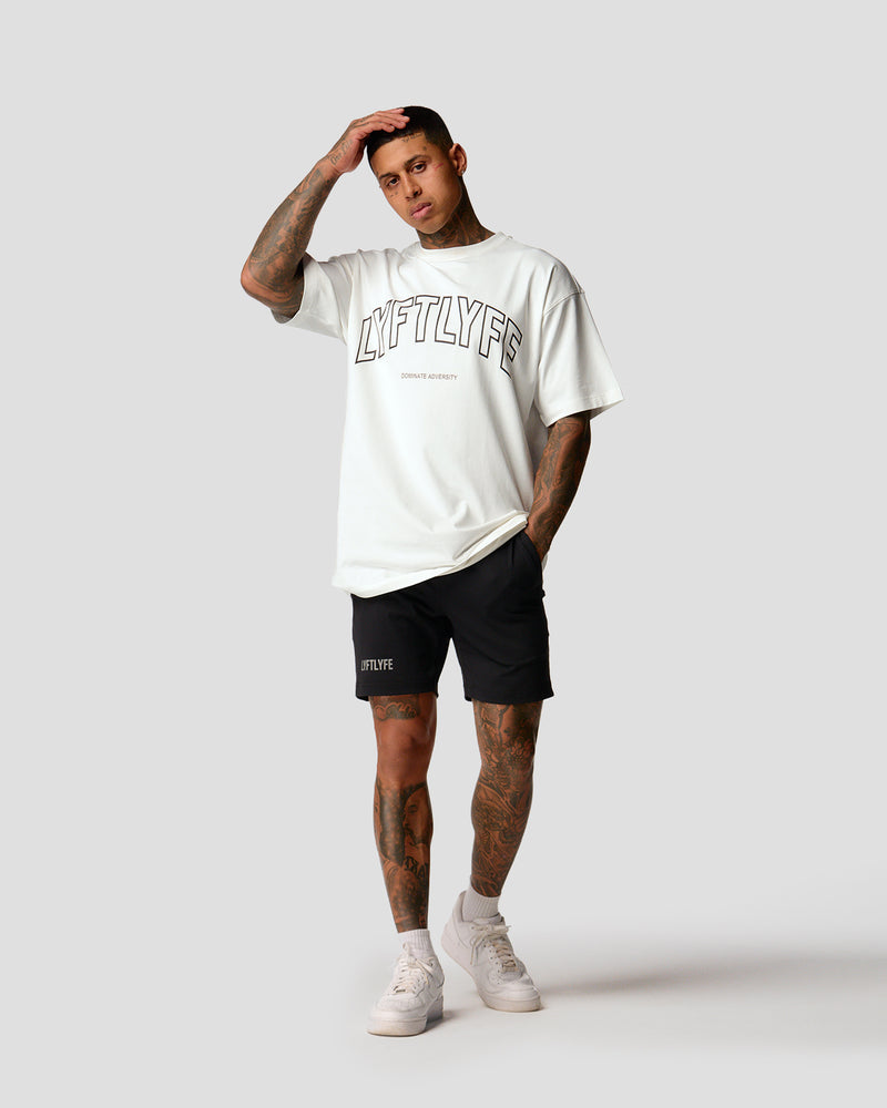 A male athlete is wearing a white, oversized T-shirt featuring a large lyftlyfe logo across the chest.