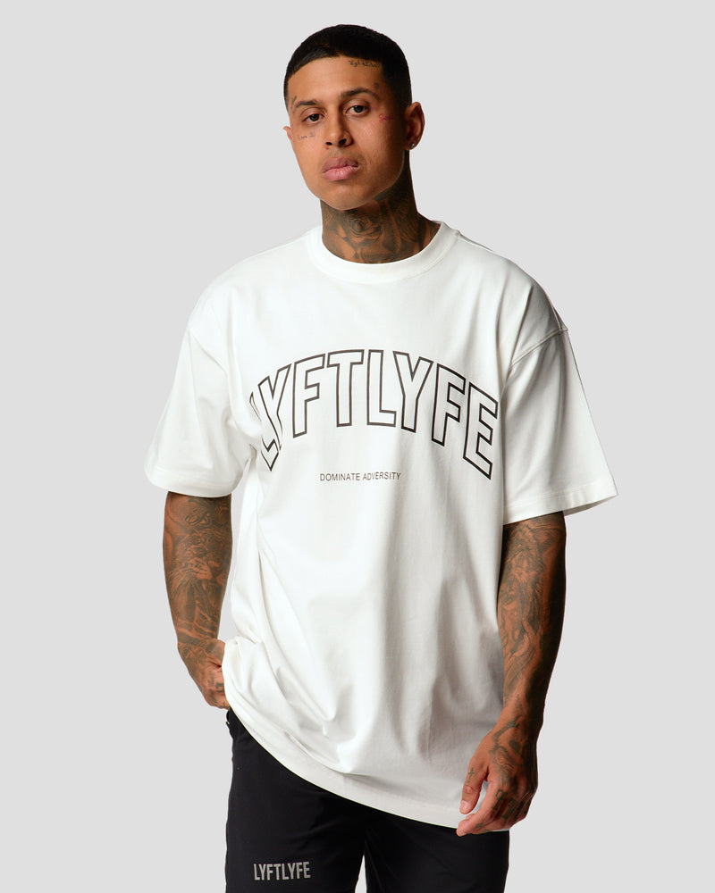 A male athlete is wearing a white, oversized T-shirt featuring a large lyftlyfe logo across the chest.