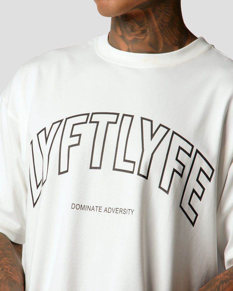 A male athlete is wearing a white, oversized T-shirt featuring a large lyftlyfe logo across the chest.