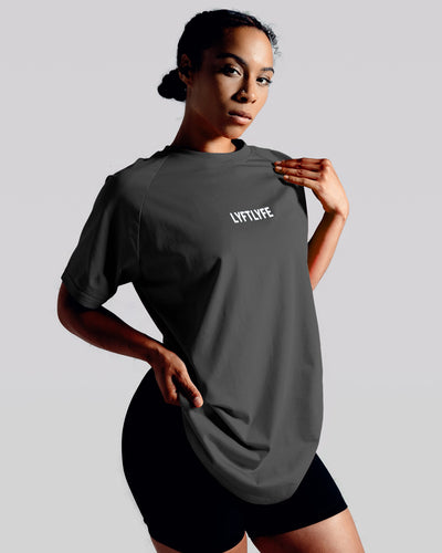 Charcoal grey LYFTLYFE contour t-shirt with white logo on light grey. 