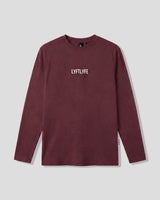 Men’s burgundy LYFTLYFE essential long sleeve shirt with white chest logo on light grey background.