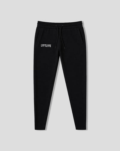 Black sweatpants with 'LYFLYFE' logo on a light gray background