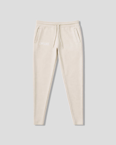 Beige sweatpants with a white LYFTLYFE logo on a light gray background