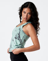 Side angle of women’s green marble tank with racerback and curved hem.