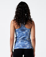 Model showing rear cut of the women’s performance tank in blue with racerback design.