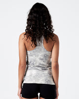 Model showing rear cut of the women’s performance tank in grey with racerback design.