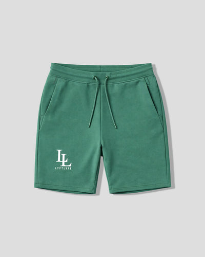 Green shorts with a logo on a light gray background