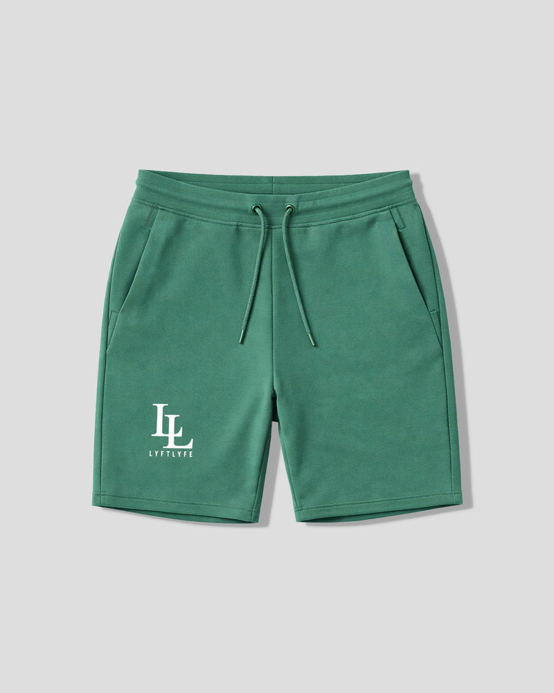 Green shorts with a logo on a light gray background