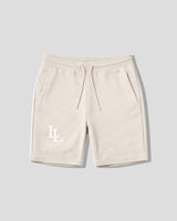 Beige shorts with a logo on a light gray background