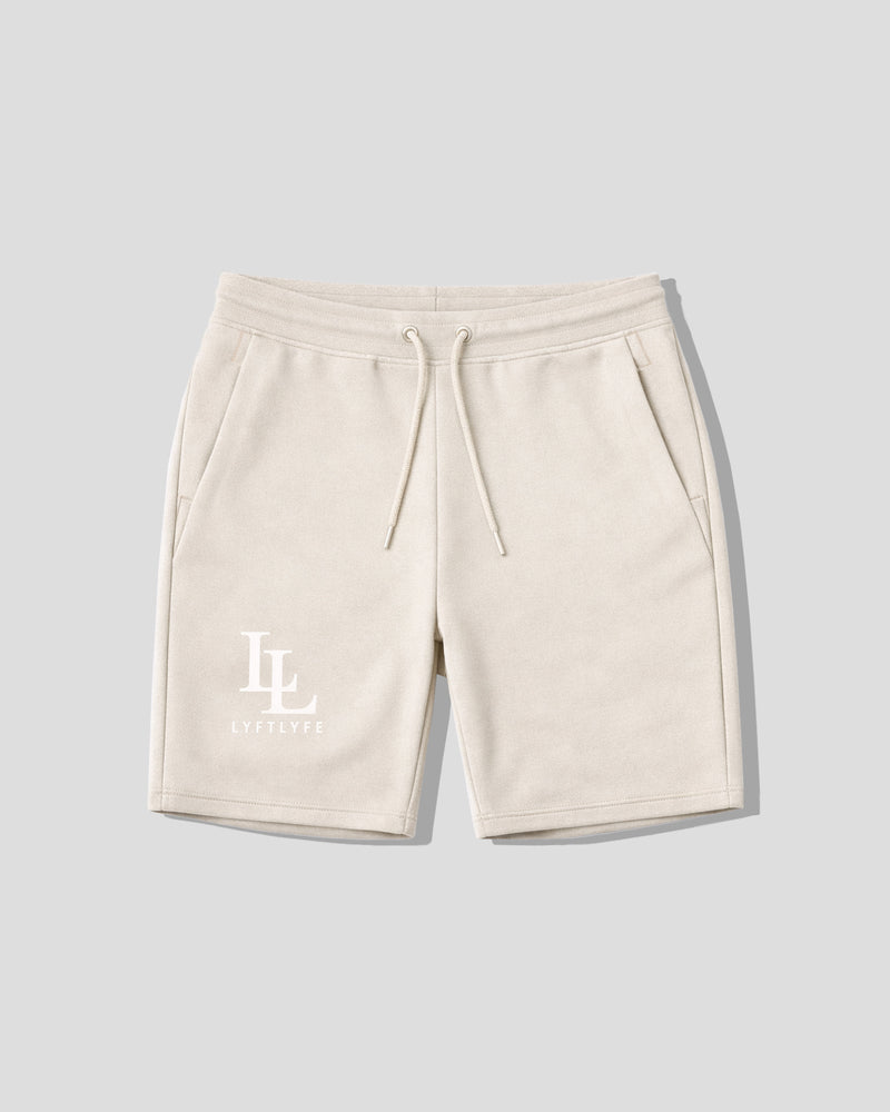 Beige shorts with a logo on a light gray background