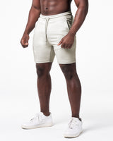 Left side view of LYFT shorts in light grey showing dual pocket seams and fitted athletic cut.