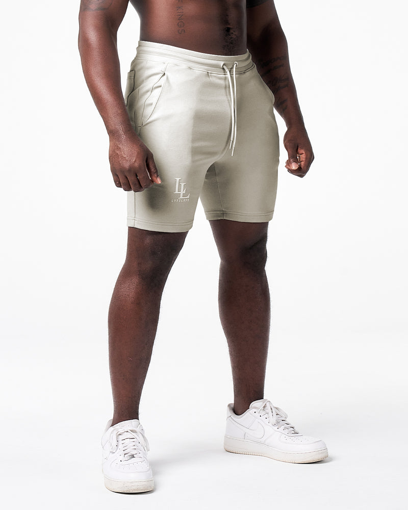 Light grey men's shorts with white LL lyftlyfe logo on the right side of the shorts. 