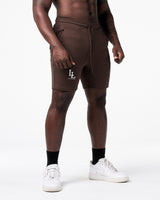 Right side view of Men’s dark brown LYFT shorts with elastic waistband and LL logo on right thigh.
