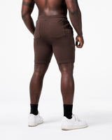 Back view of men’s dark brown LYFT shorts with dual flat seam pockets for functional storage.