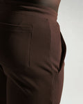 Detailed side view of dark brown shorts pocket with clean finish and deep storage.
