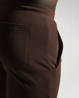 Detailed side view of dark brown shorts pocket with clean finish and deep storage.