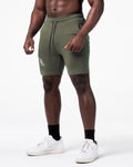 Left side view of LYFT shorts in green showing dual pocket seams and fitted athletic cut.