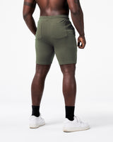 LYFT shorts in green shown from the back, showcasing relaxed fit and reinforced pocket stitching.