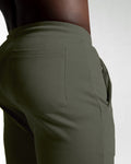 Close-up shot of LYFT shorts front and back pocket seams for secure storage in green. 