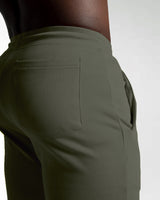 Close-up shot of LYFT shorts front and back pocket seams for secure storage in green. 