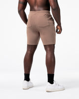 LYFT shorts in taupe shown from the back, showcasing relaxed fit and reinforced pocket stitching.