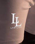 Detailed view of LYFTLYFE’s 3D rubber logo on the performance men’s shorts in taupe. 