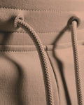 Detail shot of custom LYFTLYFE drawstring and elastic waistband in taupe. 