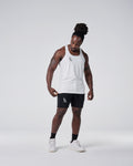 Head-to-toe look with white gym stringer and black shorts.